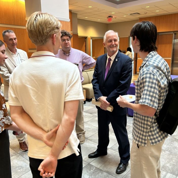 Dr. Dalton speaking with students