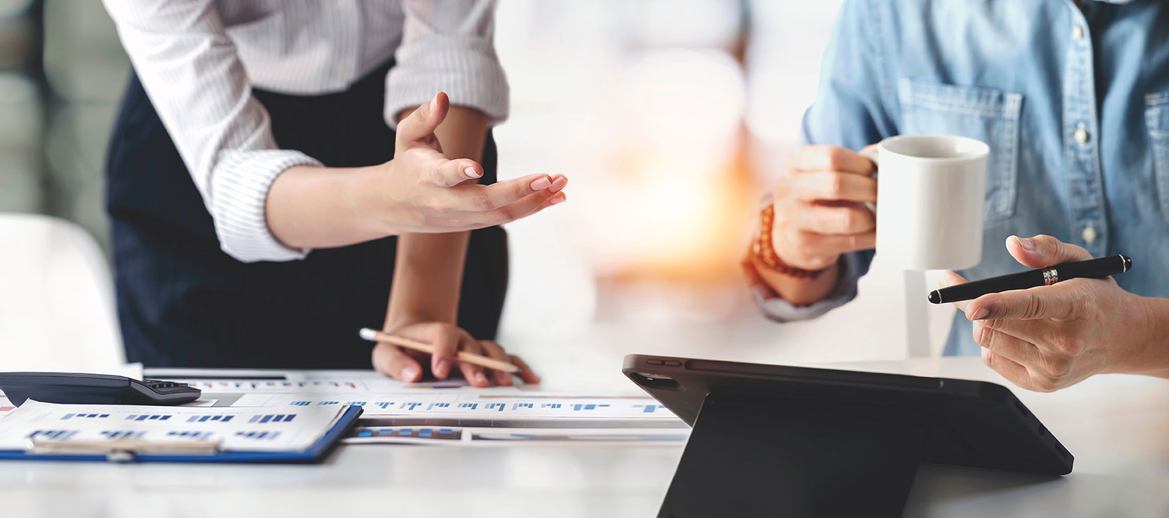 Employees leaning over a table in discussion